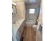 Bathroom showcasing a tub, shower, vanity, and grab bars for accessibility at 34461 Cactus Dr, Pinellas Park, FL 33781