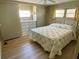 Cozy bedroom with a floral comforter, ceiling fan, and plenty of natural light at 34461 Cactus Dr, Pinellas Park, FL 33781
