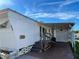 Street view of the mobile home with stairs leading up to the entrance and a carport at 34461 Cactus Dr, Pinellas Park, FL 33781
