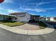 Wide angle street view of a well-maintained mobile home, with carport and small porch at 34461 Cactus Dr, Pinellas Park, FL 33781