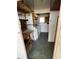 Laundry room area with washer, dryer, utility sink, and wooden storage shelves at 34461 Cactus Dr, Pinellas Park, FL 33781