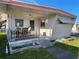 Inviting porch with seating, awning, and manicured landscaping with a sidewalk at 34461 Cactus Dr, Pinellas Park, FL 33781