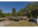 Backyard deck with railings overlooking the yard with mature trees and blue sky at 35109 Excalibur, Webster, FL 33597