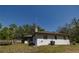 Backyard featuring the house, deck, patio and mature landscaping at 35109 Excalibur, Webster, FL 33597