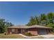 Charming single-story brick home featuring a well-maintained yard and attached garage at 35109 Excalibur, Webster, FL 33597