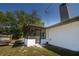 Rear view of a home featuring a screened-in porch and deck at 35109 Excalibur, Webster, FL 33597