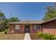 Charming brick home with a welcoming front door and landscaped front yard and walkway at 35109 Excalibur, Webster, FL 33597