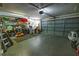 Spacious two car garage with a gray door, shelving, storage and lighting at 35109 Excalibur, Webster, FL 33597