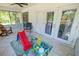 Sunroom with tile flooring, ceiling fan, neutral color paint, and multiple glass doors and windows at 35109 Excalibur, Webster, FL 33597