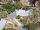 An aerial view of a home with a long driveway and a mix of mature trees surrounding the property at 422 Dunedin Cir, Temple Terrace, FL 33617