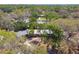 Aerial view of a charming single-story home surrounded by mature trees in a quiet neighborhood at 422 Dunedin Cir, Temple Terrace, FL 33617