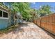 Spacious backyard with a wooden fence and lush trees, providing privacy and a serene outdoor setting at 422 Dunedin Cir, Temple Terrace, FL 33617