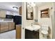Bathroom view including wood cabinets and updated fixtures adjoining kitchen at 422 Dunedin Cir, Temple Terrace, FL 33617