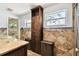 A bathroom features a modern vessel sink, granite countertops, stylish tile accents, and wood cabinetry at 422 Dunedin Cir, Temple Terrace, FL 33617