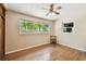Bedroom with hardwood floors and a large window providing plenty of natural light at 422 Dunedin Cir, Temple Terrace, FL 33617