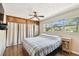 A bedroom features hardwood floors, a large window with natural light, and a built-in closet at 422 Dunedin Cir, Temple Terrace, FL 33617