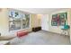 Bright bonus room with a large window, a door to the outside, and a decorative quilt on the wall at 422 Dunedin Cir, Temple Terrace, FL 33617