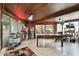 Bonus room with a paneled ceiling, large table, and access to the outside at 422 Dunedin Cir, Temple Terrace, FL 33617