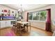 Bright dining area featuring hardwood floors, a built-in bar area and natural light at 422 Dunedin Cir, Temple Terrace, FL 33617