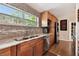 Updated kitchen with stainless steel appliances and granite countertops under a bright window at 422 Dunedin Cir, Temple Terrace, FL 33617