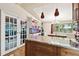 Modern kitchen features an island with granite countertops, sleek cabinets, and stylish pendant lighting at 422 Dunedin Cir, Temple Terrace, FL 33617