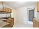 Functional kitchen features wood cabinets, ample counter space, a dark sink, and tile flooring at 422 Dunedin Cir, Temple Terrace, FL 33617