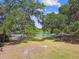 Picturesque lake view framed by mature trees, showcasing a peaceful waterfront setting under a blue sky at 422 Dunedin Cir, Temple Terrace, FL 33617