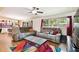 Bright living room featuring hardwood floors and comfortable seating open to the dining area at 422 Dunedin Cir, Temple Terrace, FL 33617