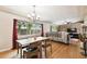 Spacious dining room and living area with hardwood floors, chandelier, and large window views at 422 Dunedin Cir, Temple Terrace, FL 33617