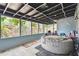 Covered patio with an inflatable hot tub, offering a relaxing outdoor space for leisure and entertainment at 422 Dunedin Cir, Temple Terrace, FL 33617