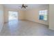 Bedroom featuring tile floors, large window, and a sliding glass door at 4235 Angelica Loop, Wesley Chapel, FL 33543