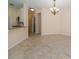 An open-concept living and dining area showcases tile flooring and modern lighting at 4235 Angelica Loop, Wesley Chapel, FL 33543