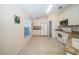 Kitchen with white cabinets, stainless appliances, tile backsplash, and a view of the outdoors at 4235 Angelica Loop, Wesley Chapel, FL 33543