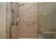 The accessible shower features tile surround, glass door, and hand rails for safety and convenience at 4235 Angelica Loop, Wesley Chapel, FL 33543