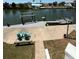 Waterfront backyard with a private dock, a boat lift, and a cozy seating area at 4275 Bellaire Dr, Hernando Beach, FL 34607