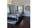 Cozy bedroom with dark hardwood floors, ceiling fan, and windows that provide ample natural light at 4275 Bellaire Dr, Hernando Beach, FL 34607