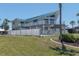 A spacious home boasts an expansive deck, light-blue metal roof, and fenced yard at 4275 Bellaire Dr, Hernando Beach, FL 34607