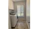 Convenient laundry room featuring a washer, dryer, and ample natural light at 4275 Bellaire Dr, Hernando Beach, FL 34607