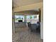 Covered outdoor kitchen, with a built-in grill, stone accents, and ample seating at 4275 Bellaire Dr, Hernando Beach, FL 34607