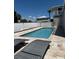 Backyard pool area with lounge chairs, privacy fencing, and a tropical ambiance at 4275 Bellaire Dr, Hernando Beach, FL 34607