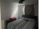 Simple bedroom with patterned bedding, and ceiling fan at 4503 W Minnehaha St, Tampa, FL 33614