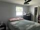 Relaxing bedroom with ceiling fan, window views, and adjacent bathroom access at 4503 W Minnehaha St, Tampa, FL 33614