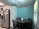 Cozy dining area with a dark wood table, seating for four, and modern lighting fixture at 4503 W Minnehaha St, Tampa, FL 33614