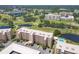 Lovely aerial view showcasing a residential building near a golf course, pools and natural ponds at 4550 Pinebrook Cir # 505, Bradenton, FL 34209
