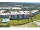 Aerial view of condo buildings, sparkling swimming pool, and well-manicured green spaces at 4550 Pinebrook Cir # 505, Bradenton, FL 34209
