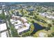 Beautiful aerial view of a golf course community, featuring lush fairways, scenic ponds, and residential buildings at 4550 Pinebrook Cir # 505, Bradenton, FL 34209