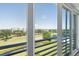 Balcony view overlooking the golf course, pond, and distant buildings at 4550 Pinebrook Cir # 505, Bradenton, FL 34209
