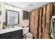 Cozy bathroom featuring framed mirror, vanity cabinet, updated toilet, and a decorative shower curtain at 4550 Pinebrook Cir # 505, Bradenton, FL 34209