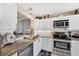 A well-equipped kitchen with white cabinets, stainless steel appliances, and a modern design at 4550 Pinebrook Cir # 505, Bradenton, FL 34209