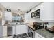 This kitchen boasts white cabinetry, granite countertops, stainless appliances, and abundant natural light at 4550 Pinebrook Cir # 505, Bradenton, FL 34209